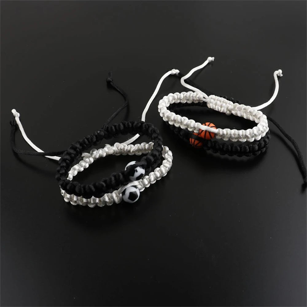 Paracord bracelet with a central basketball bead, available in black and white, perfect for sports fans and athletes seeking a stylish accessory.