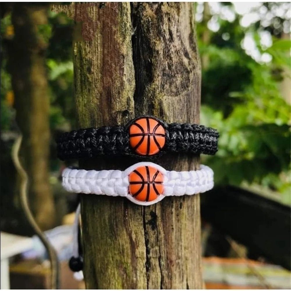 Paracord bracelet with a central basketball bead, available in black and white, perfect for sports fans and athletes seeking a stylish accessory.