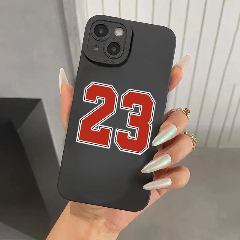 Premium black iPhone case featuring the iconic number 23 in bold red and white outline, perfect for basketball enthusiasts and fans of legendary players. The sleek matte finish provides a firm grip, while the precise camera cutout maintains full functionality. Ideal for protecting your smartphone while showcasing your sports passion with a stylish and durable design.